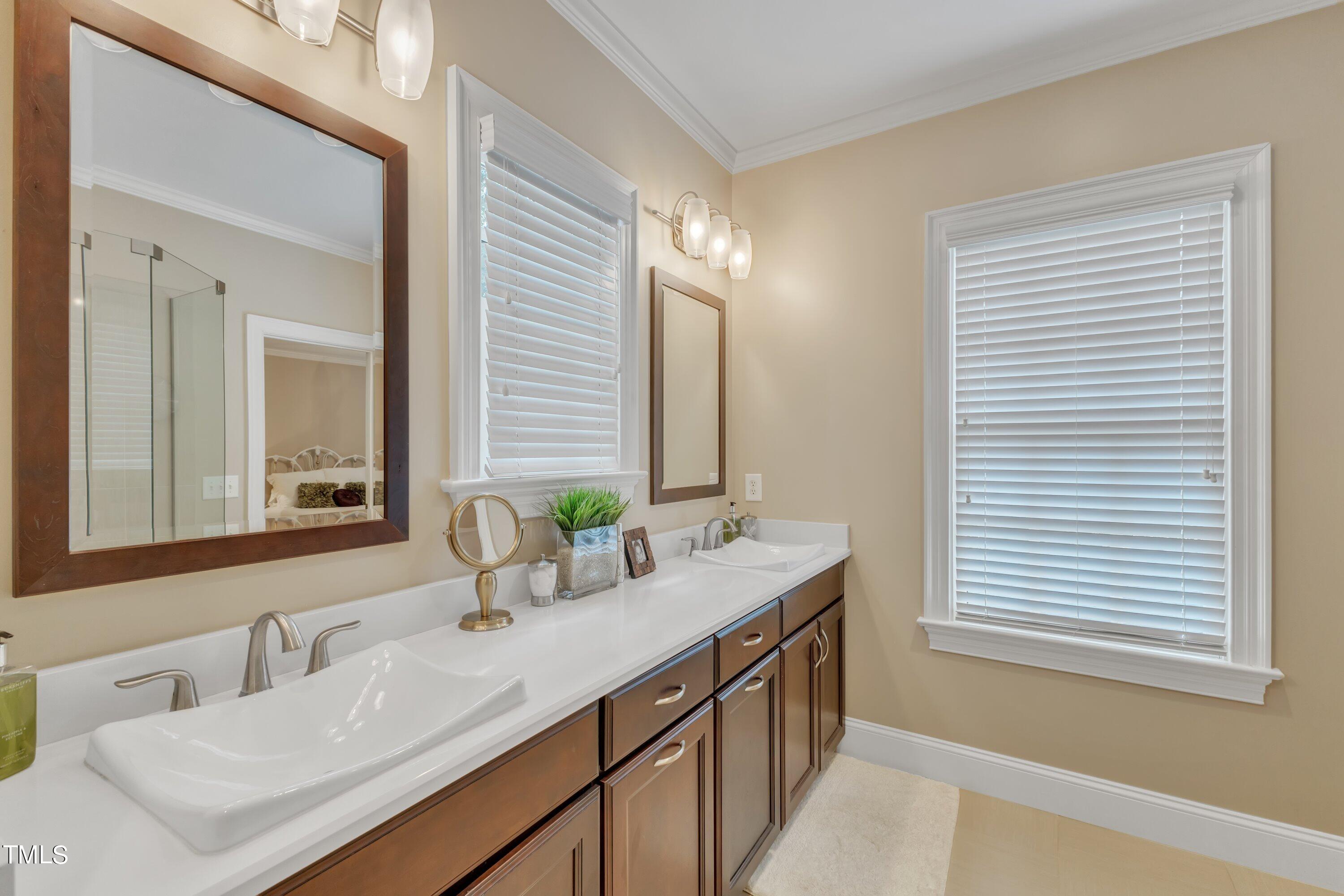11220 Brass Kettle Road Raleigh, NC 27614 - Photo 38 of 86 a bathroom with a sink and a mirror