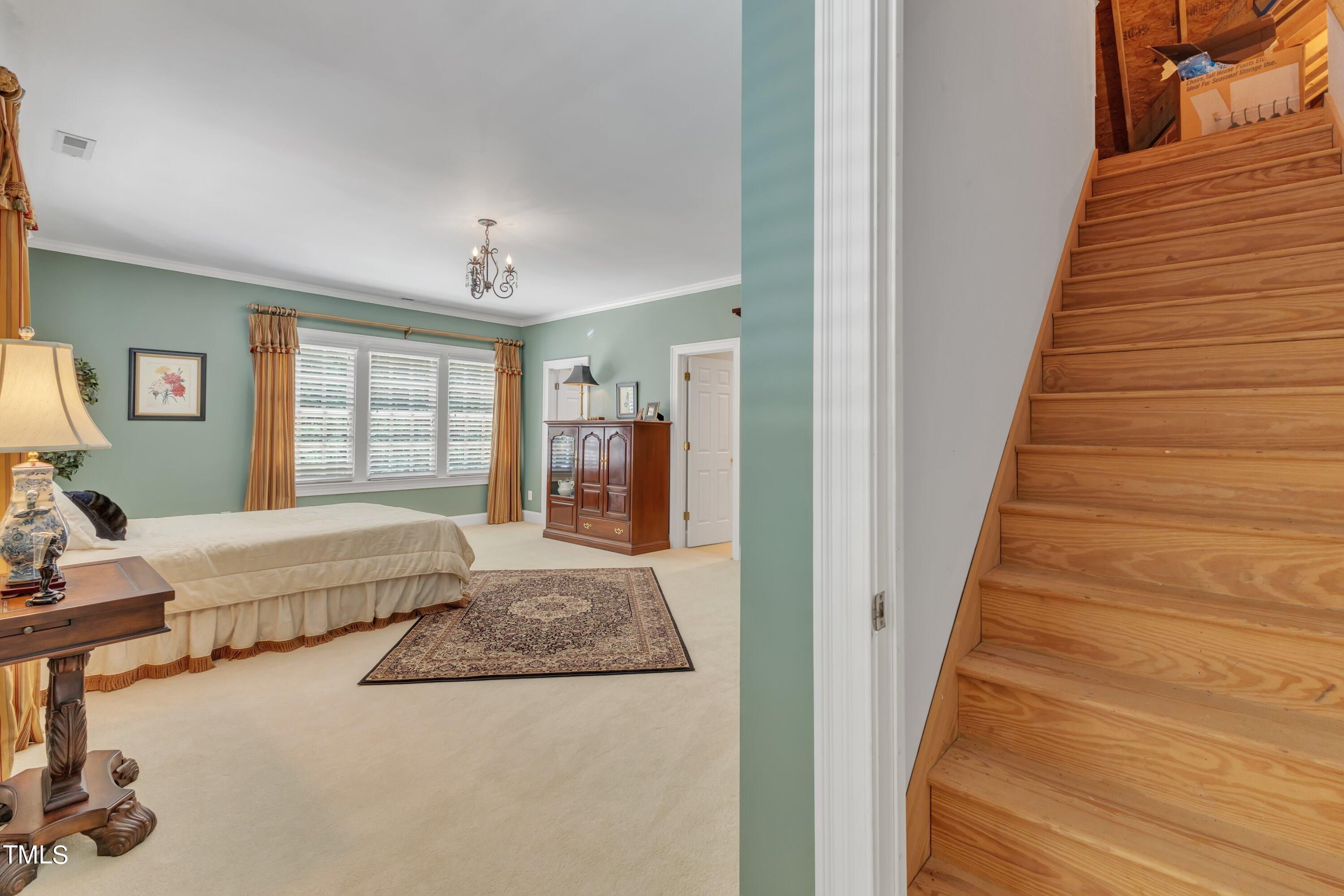 11220 Brass Kettle Road Raleigh, NC 27614 - Photo 39 of 86 a spacious bedroom with a bed and a window