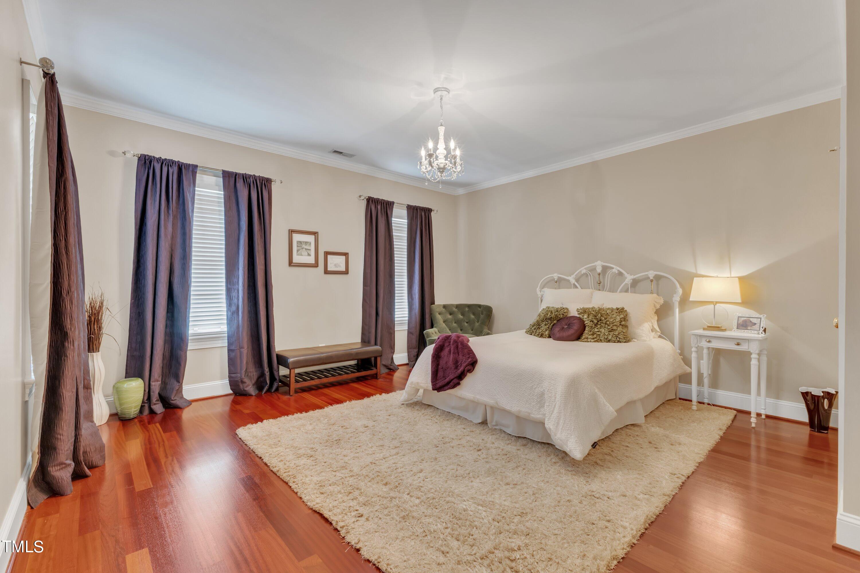 11220 Brass Kettle Road Raleigh, NC 27614 - Photo 40 of 86 a bedroom with a bed and a large mirror on the dresser