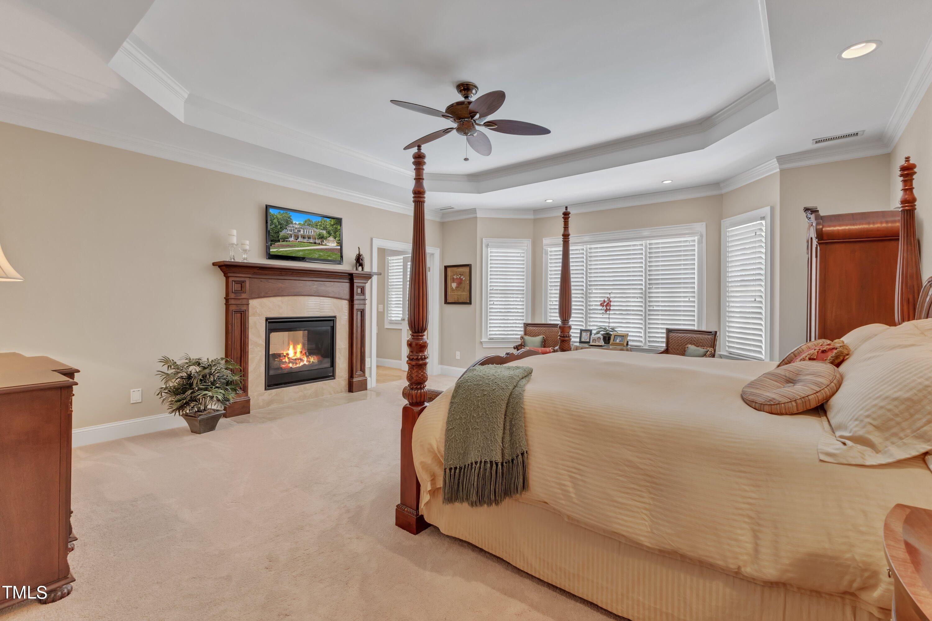 11220 Brass Kettle Road Raleigh, NC 27614 - Photo 42 of 86 a bedroom with a bed and a fireplace
