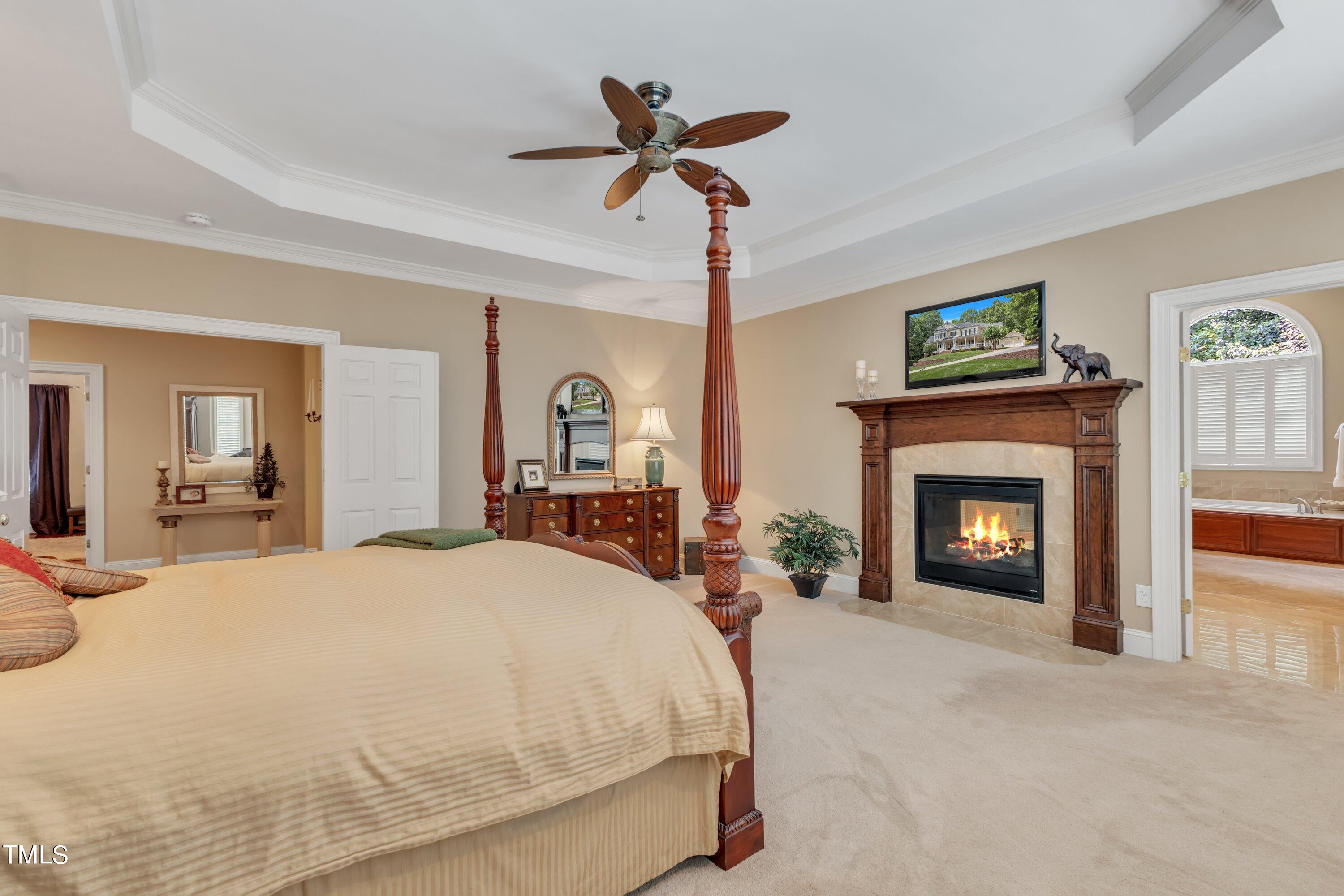 11220 Brass Kettle Road Raleigh, NC 27614 - Photo 44 of 86 a bed room with a bed and a fireplace