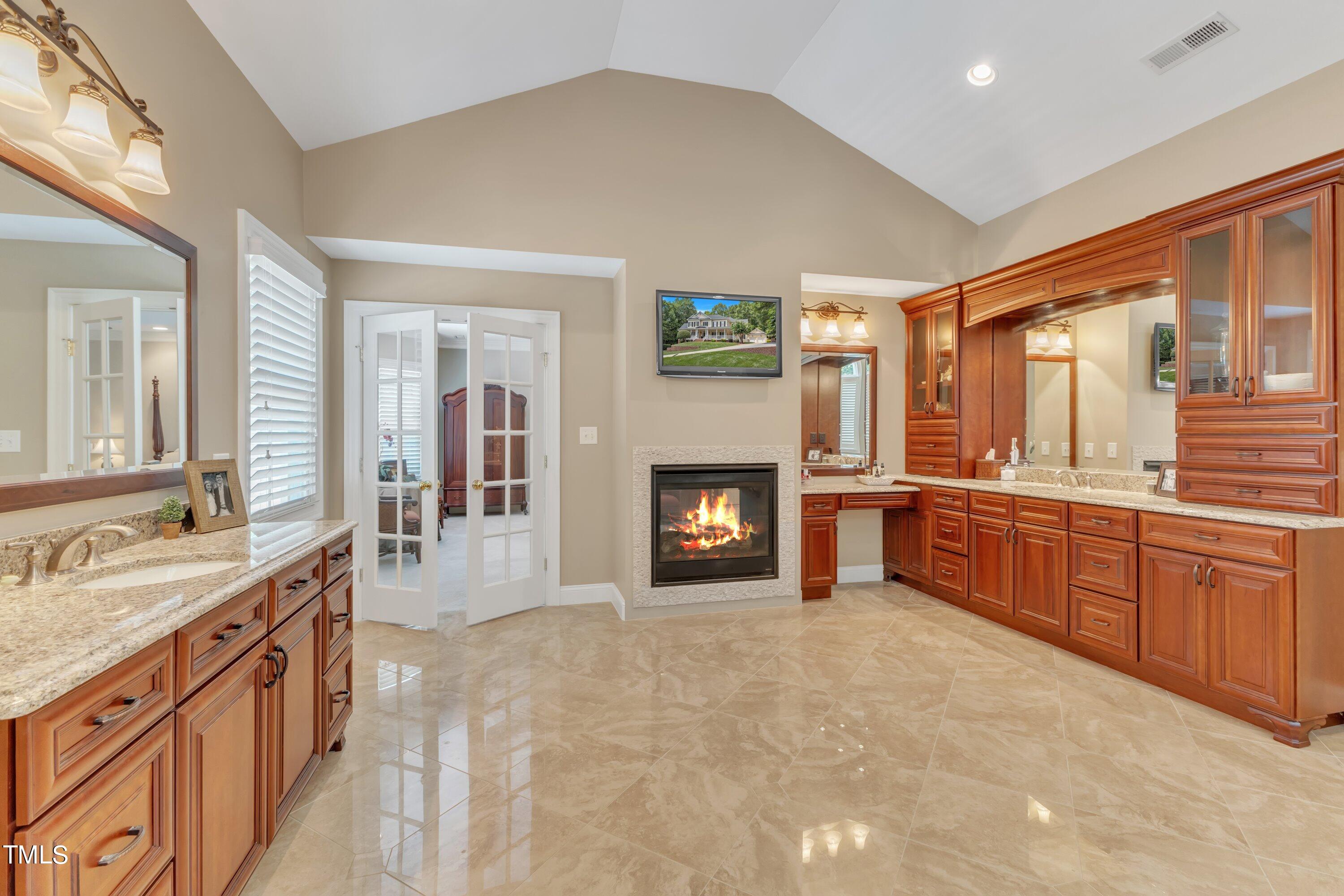 11220 Brass Kettle Road Raleigh, NC 27614 - Photo 48 of 86 a large spacious bathroom with a granite countertop double vanity sink a mirror and a bathtub