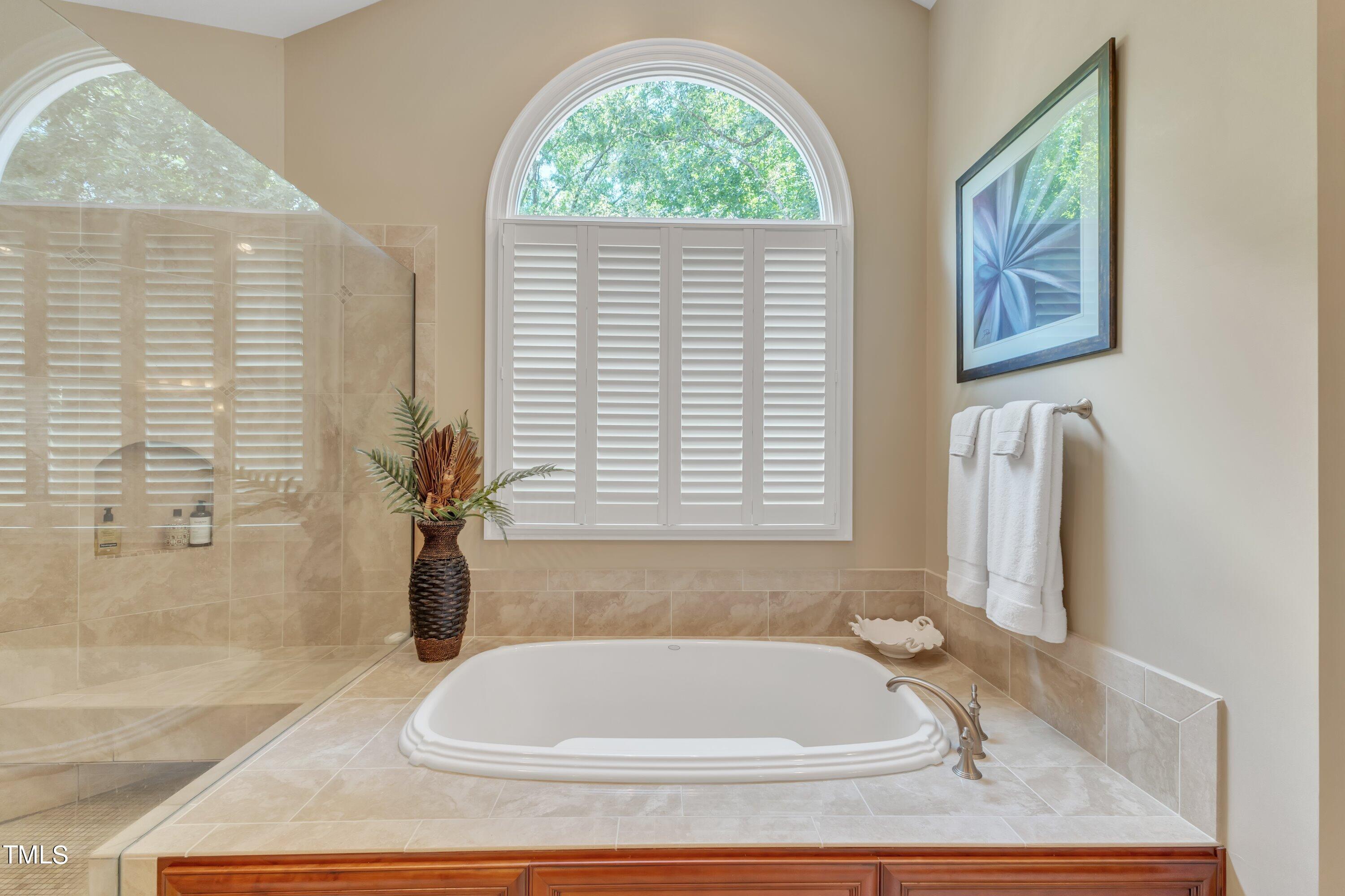 11220 Brass Kettle Road Raleigh, NC 27614 - Photo 49 of 86 a bath tub sitting in a bathroom next to a window