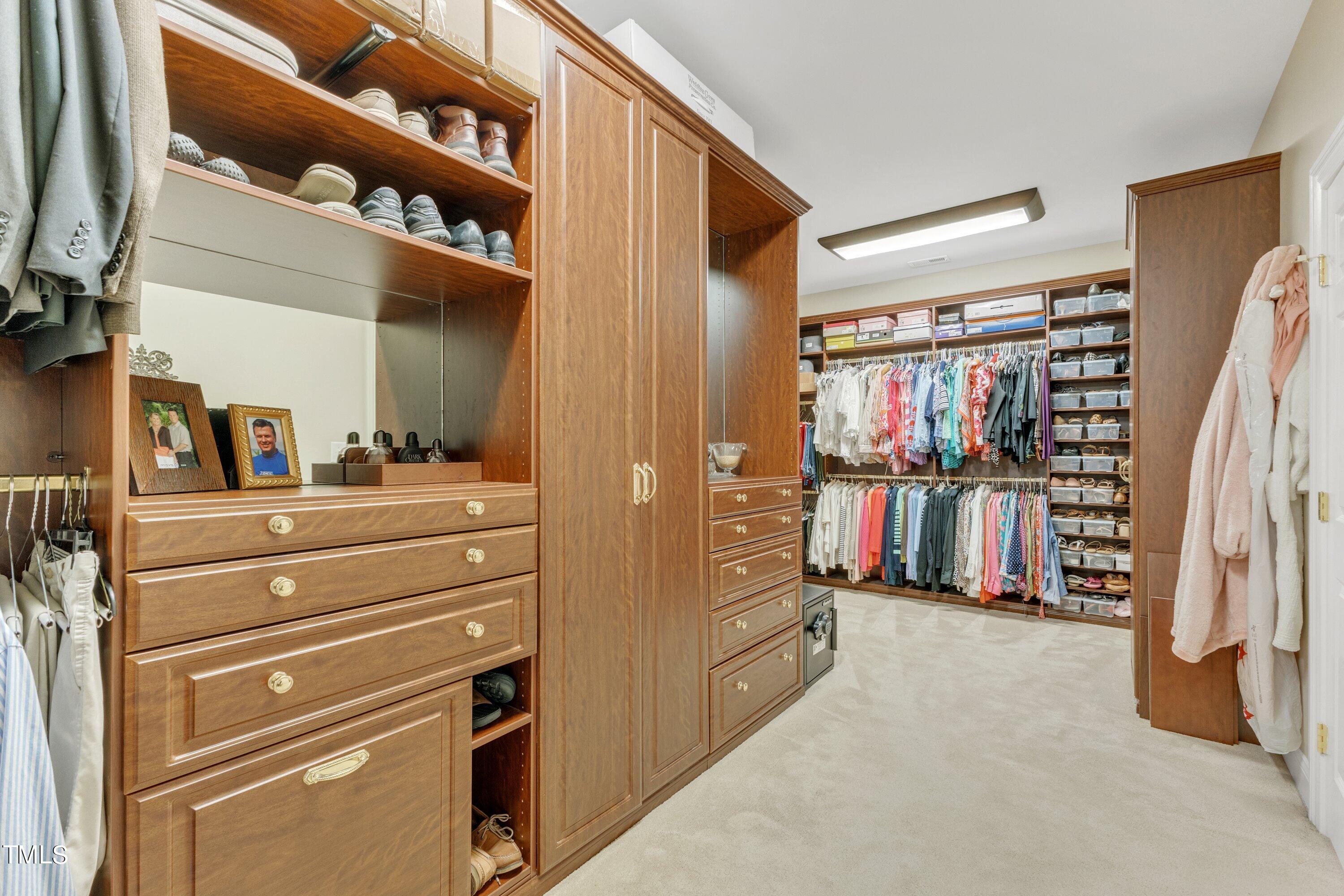 11220 Brass Kettle Road Raleigh, NC 27614 - Photo 51 of 86 a view of walk in closet with clothes and shoes