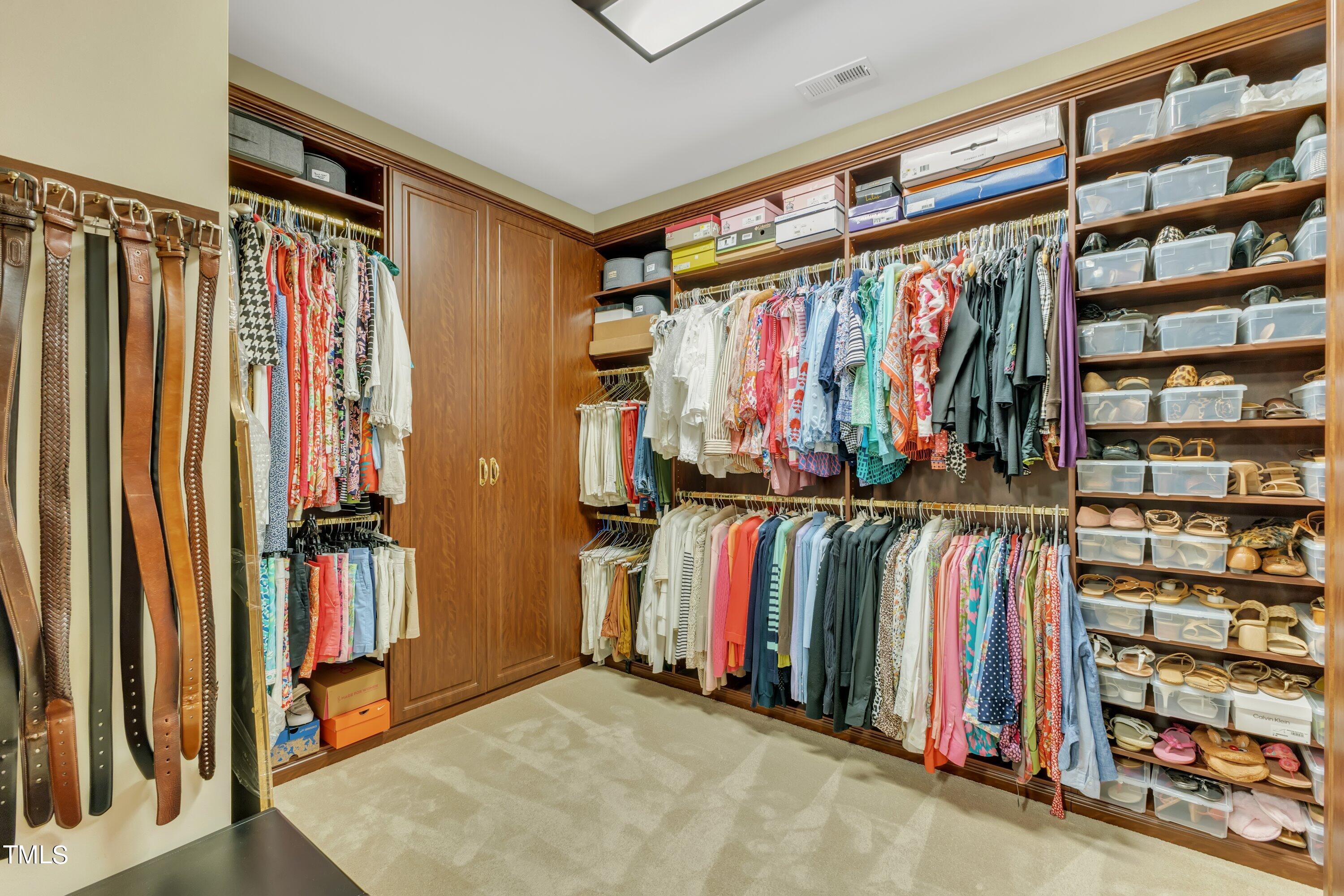 11220 Brass Kettle Road Raleigh, NC 27614 - Photo 52 of 86 a view of walk in closet with clothes and shoes