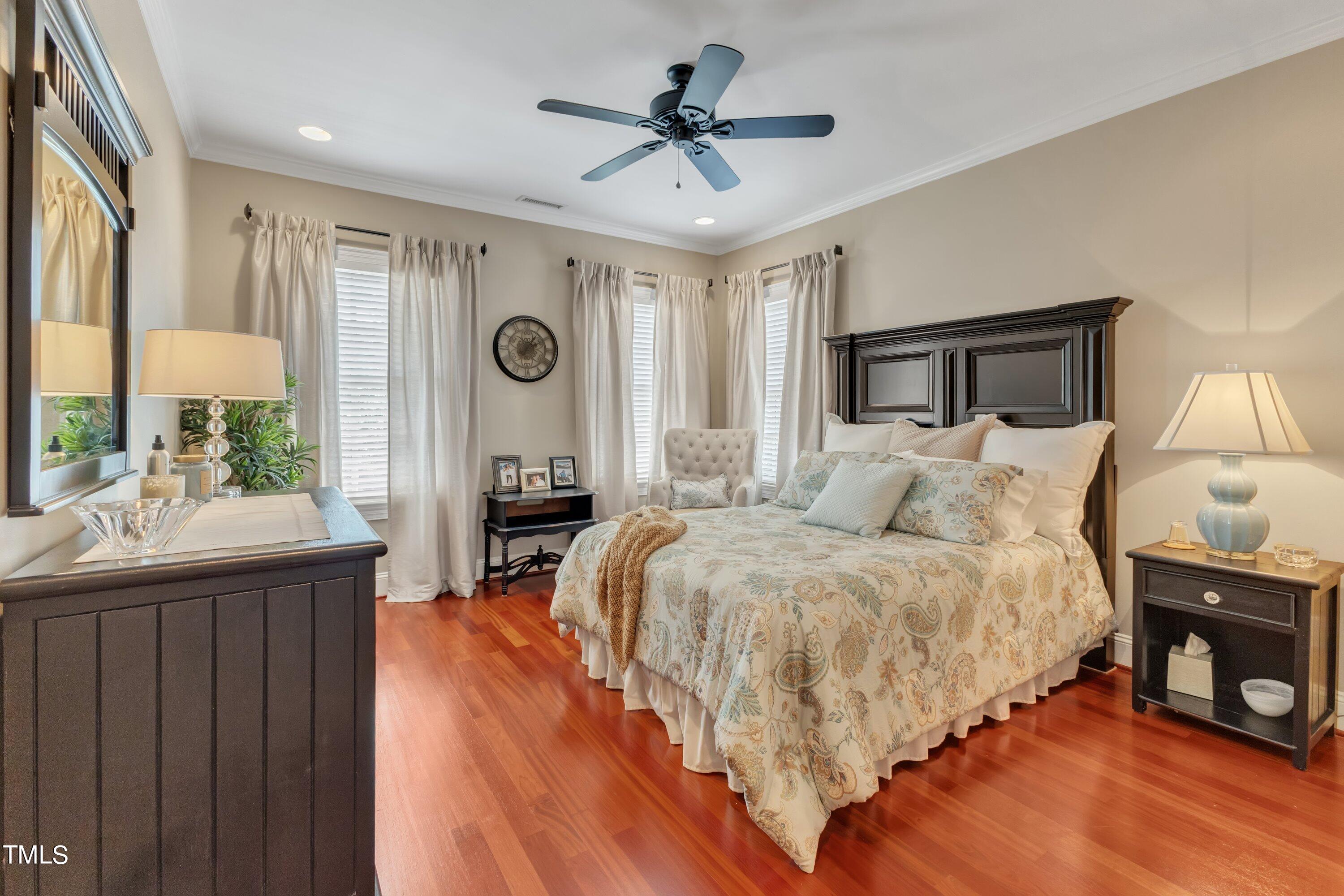 11220 Brass Kettle Road Raleigh, NC 27614 - Photo 57 of 86 a spacious bedroom with a bed a table and a large mirror