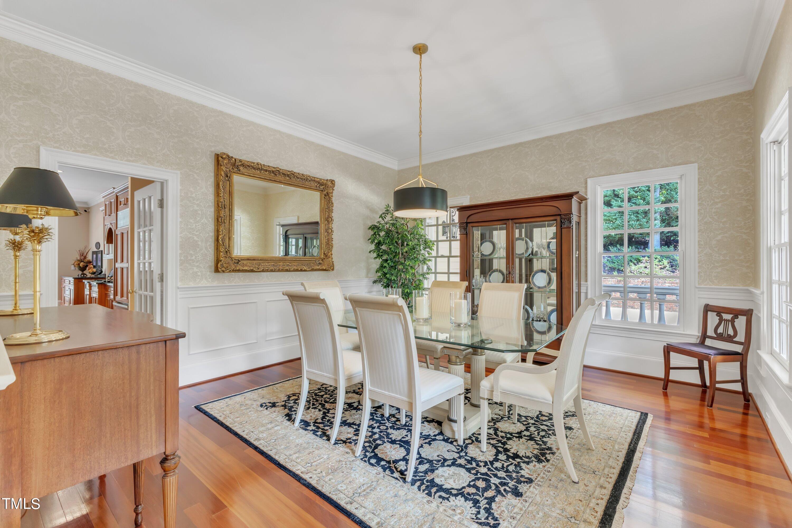 11220 Brass Kettle Road Raleigh, NC 27614 - Photo 6 of 86 a view of a dining room with furniture a chandelier and wooden floor