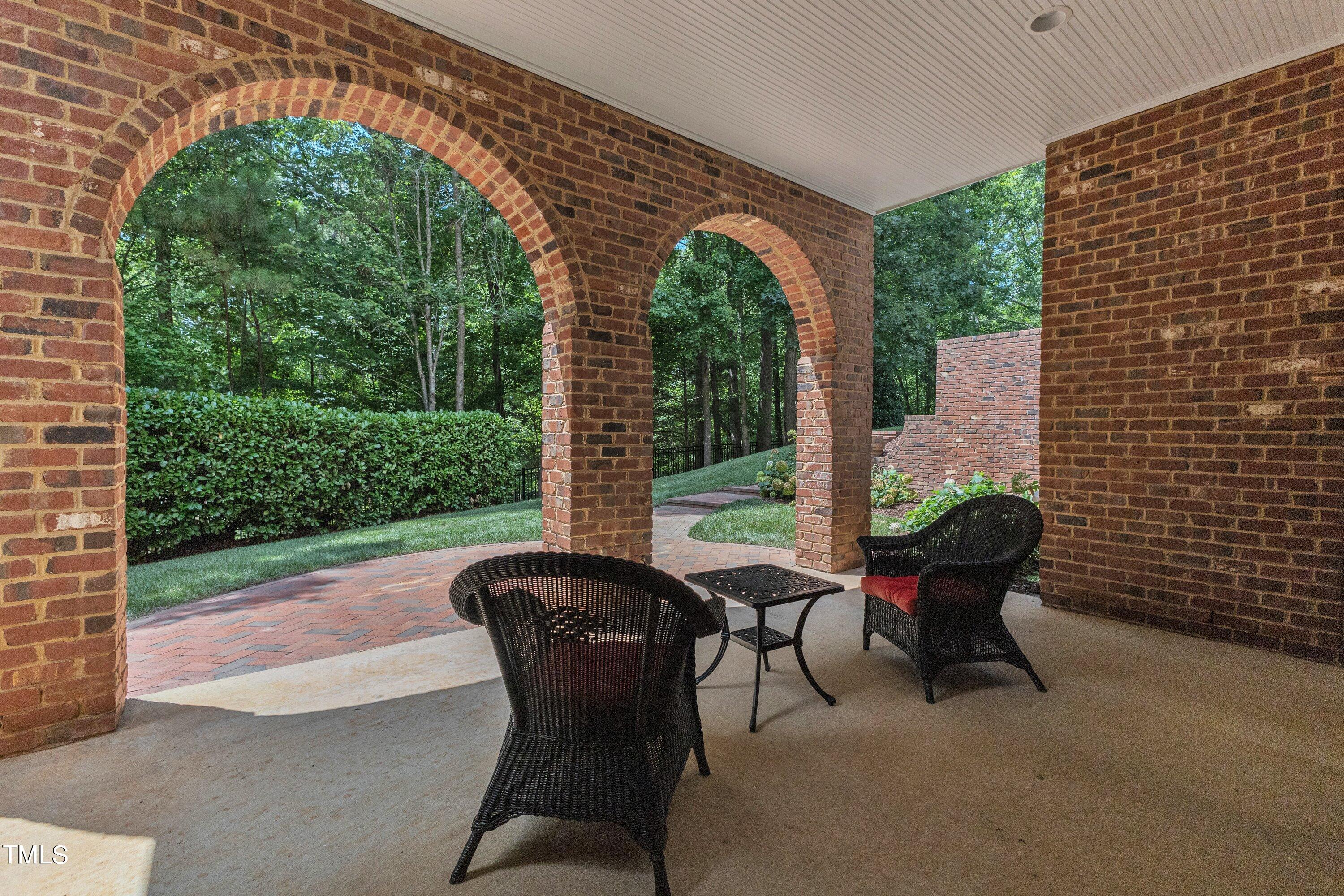 11220 Brass Kettle Road Raleigh, NC 27614 - Photo 64 of 86 a view of a patio with table and chairs and floor to ceiling window