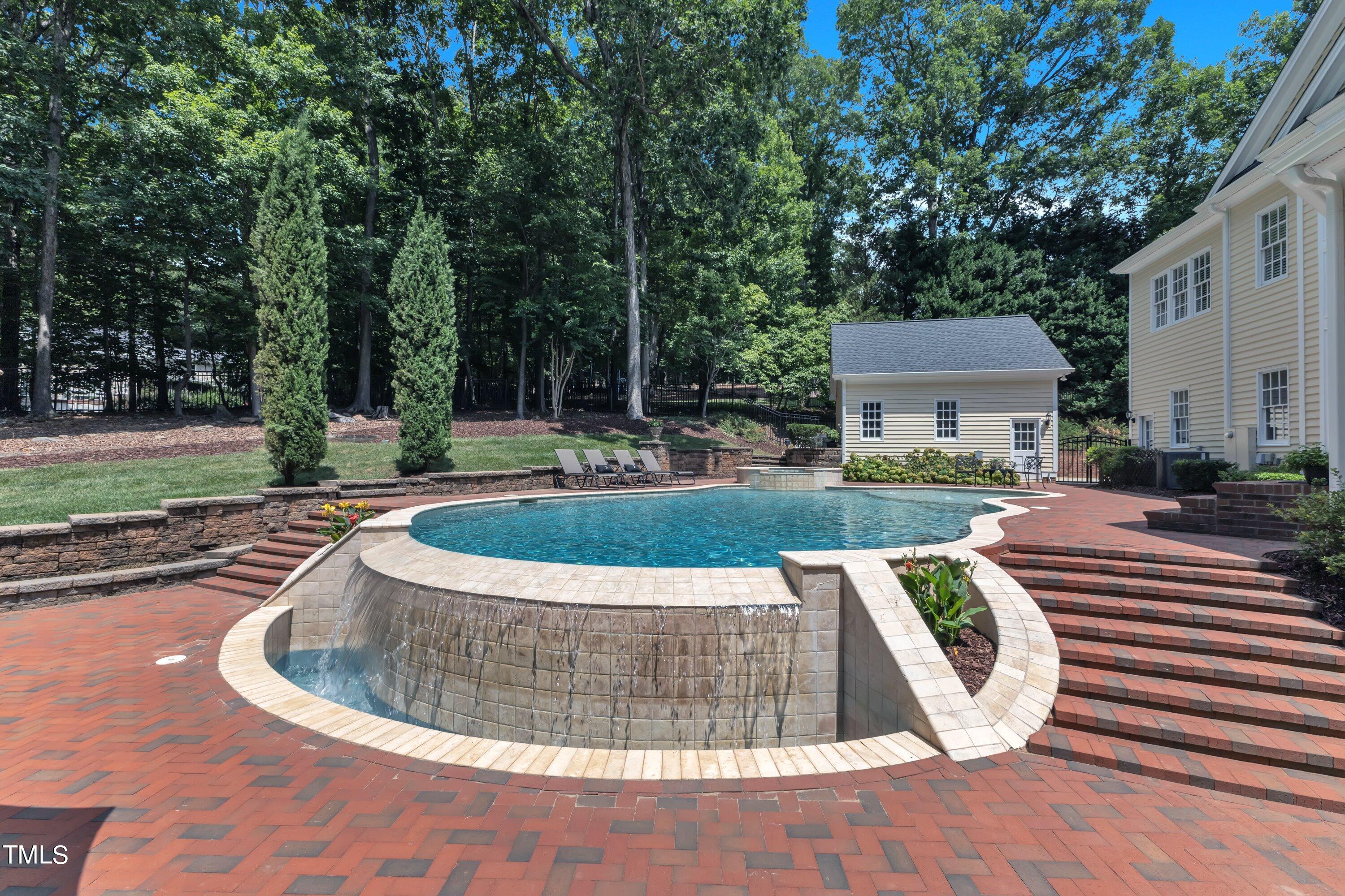 11220 Brass Kettle Road Raleigh, NC 27614 - Photo 70 of 86 a view of a swimming pool with a sitting space