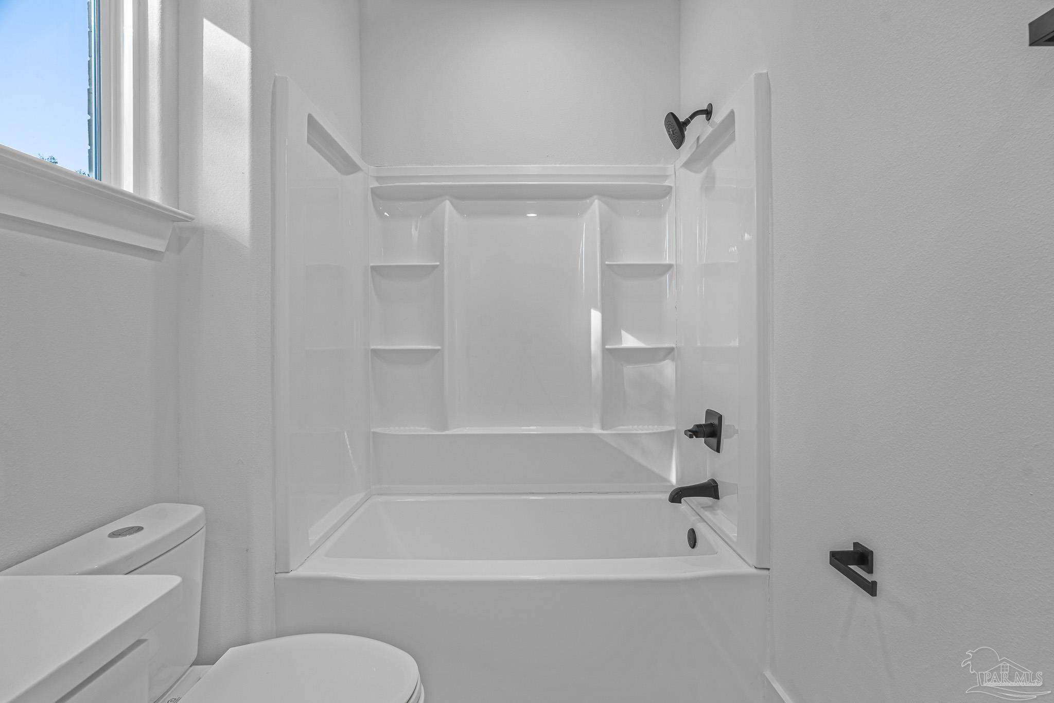 5005 Saufley Field Road Pensacola, FL 32526 - Photo 14 of 27 a bathroom with a toilet and a bathtub