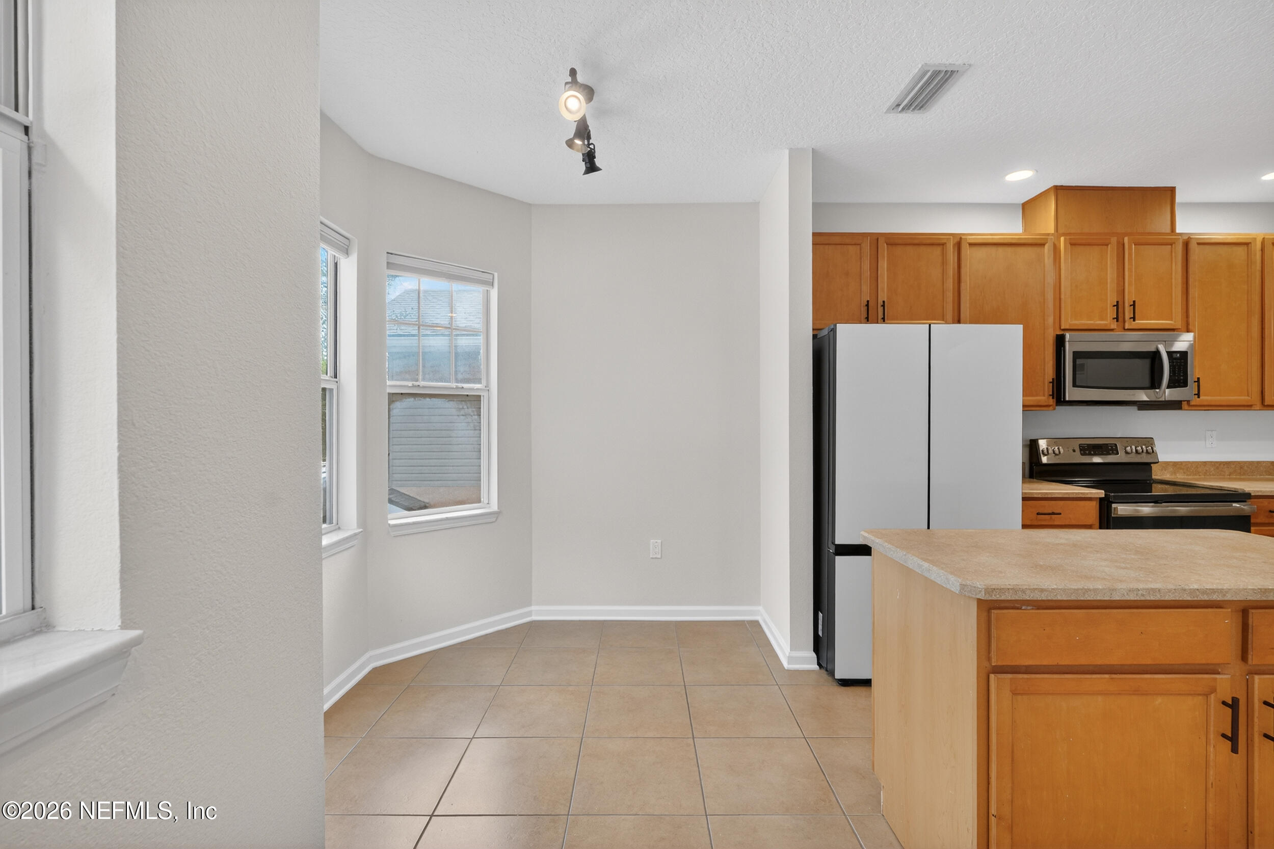 5663 Greenland Road, Unit 1304 Jacksonville, FL 32258 - Photo 12 of 41 a kitchen with a refrigerator and a stove top oven