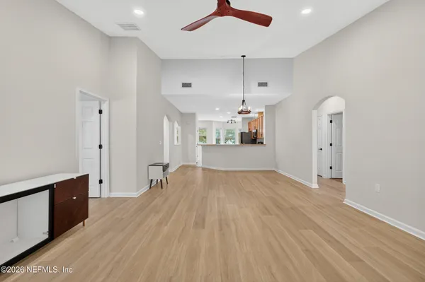 a view of empty room with wooden floor