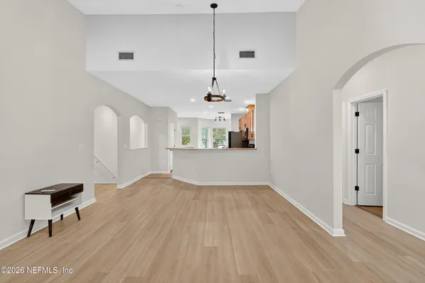 a view of a kitchen with wooden floor and a sink