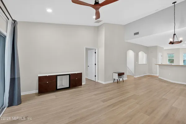 a view of empty room with wooden floor