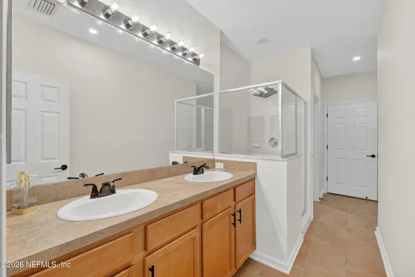 a bathroom with a sink double vanity and a mirror