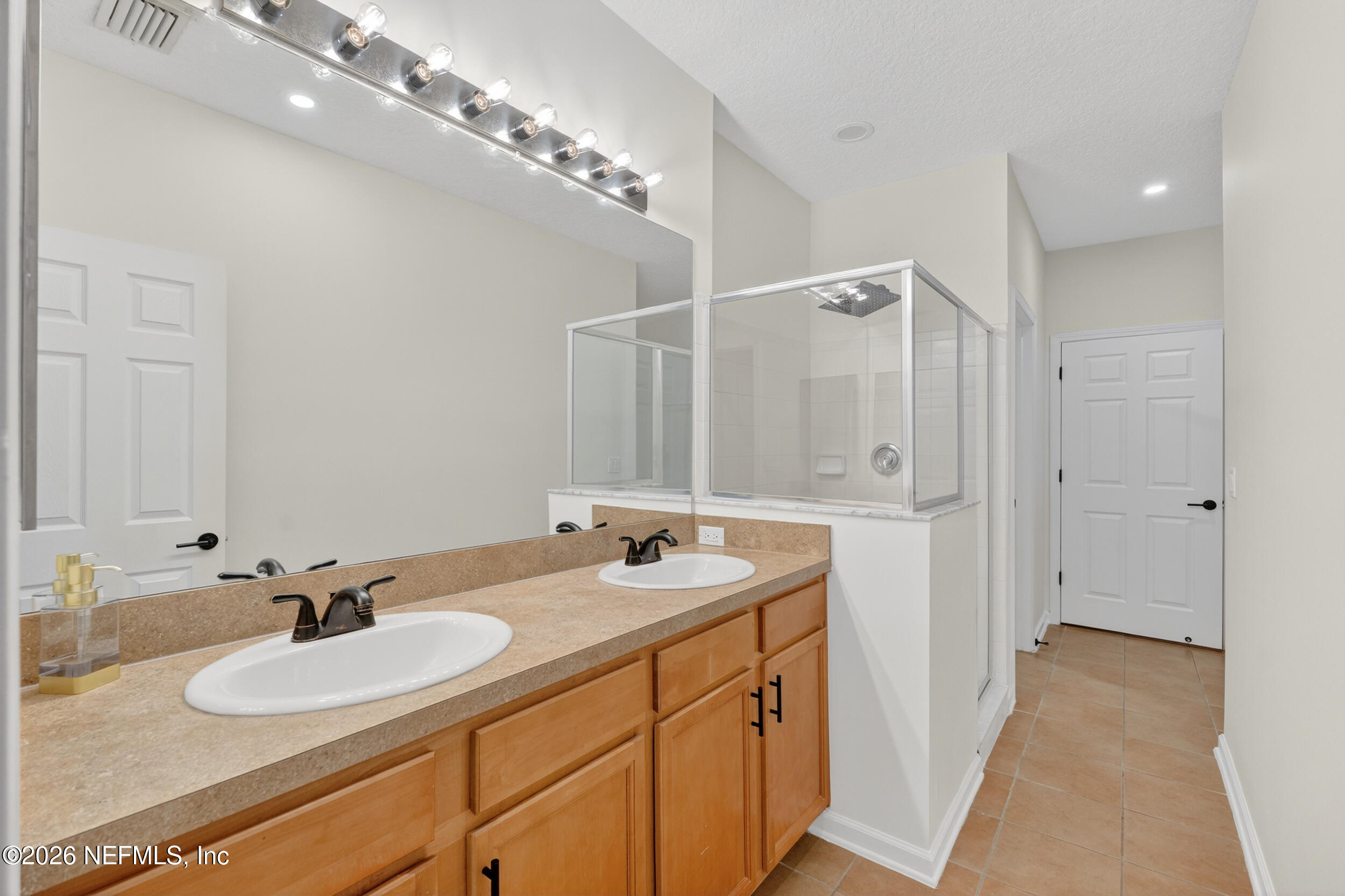 5663 Greenland Road, Unit 1304 Jacksonville, FL 32258 - Photo 23 of 41 a bathroom with a sink double vanity and a mirror