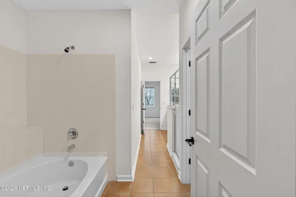 a bathroom with a bathtub and a shower