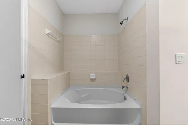a white bath tub sitting in a bathroom