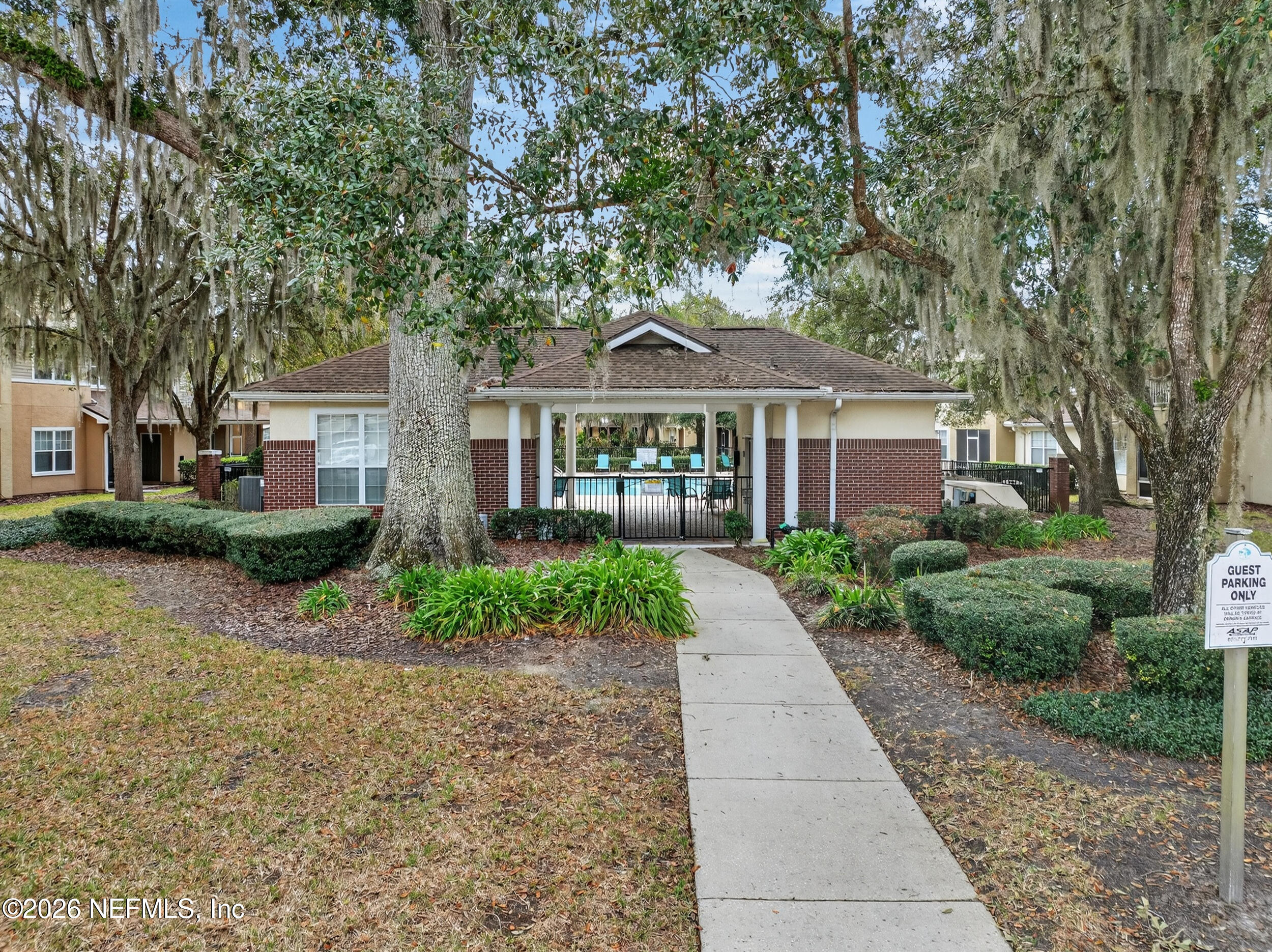 5663 Greenland Road, Unit 1304 Jacksonville, FL 32258 - Photo 38 of 41 a front view of a house with a garden and trees