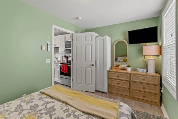 a bedroom with a bed and a flat screen tv