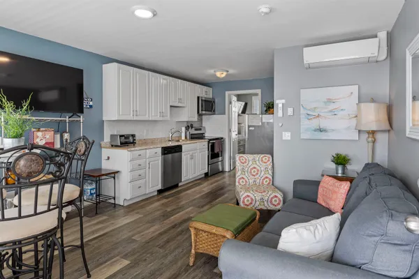 a living room with furniture and a kitchen view