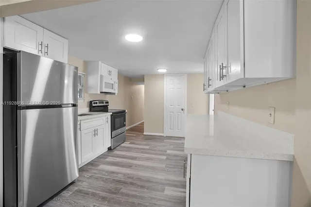 a kitchen with a refrigerator and a refrigerator