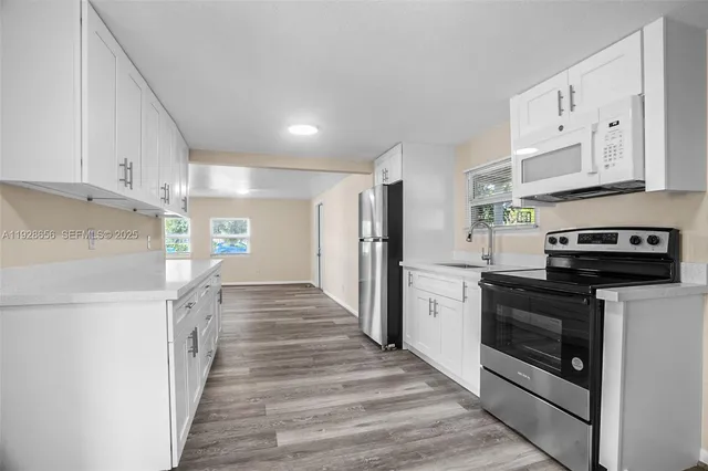 a kitchen with stainless steel appliances a stove microwave and cabinets