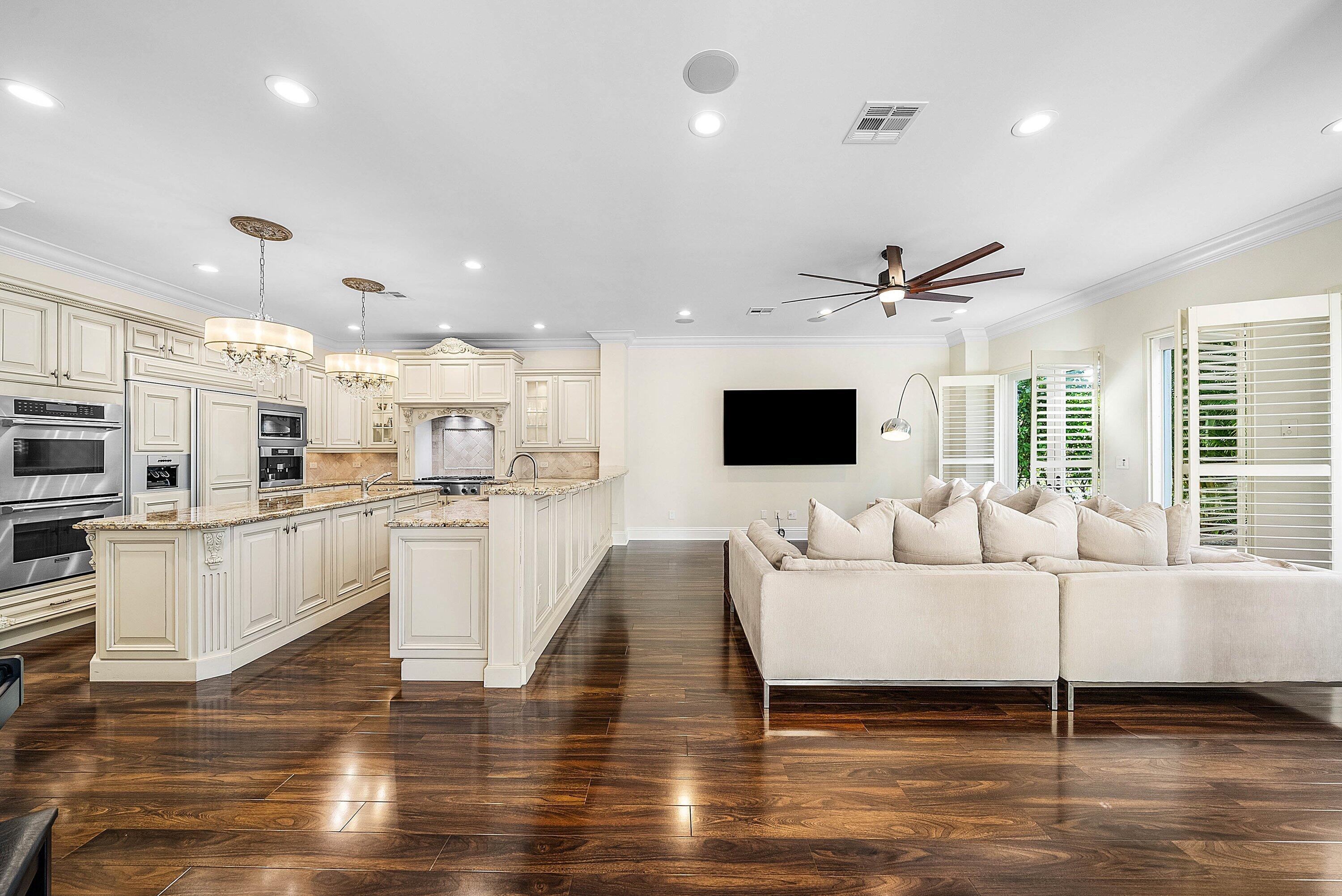 398 Northeast 7th Street Boca Raton, FL 33432 - Photo 13 of 74 a living room with kitchen island furniture and a flat screen tv