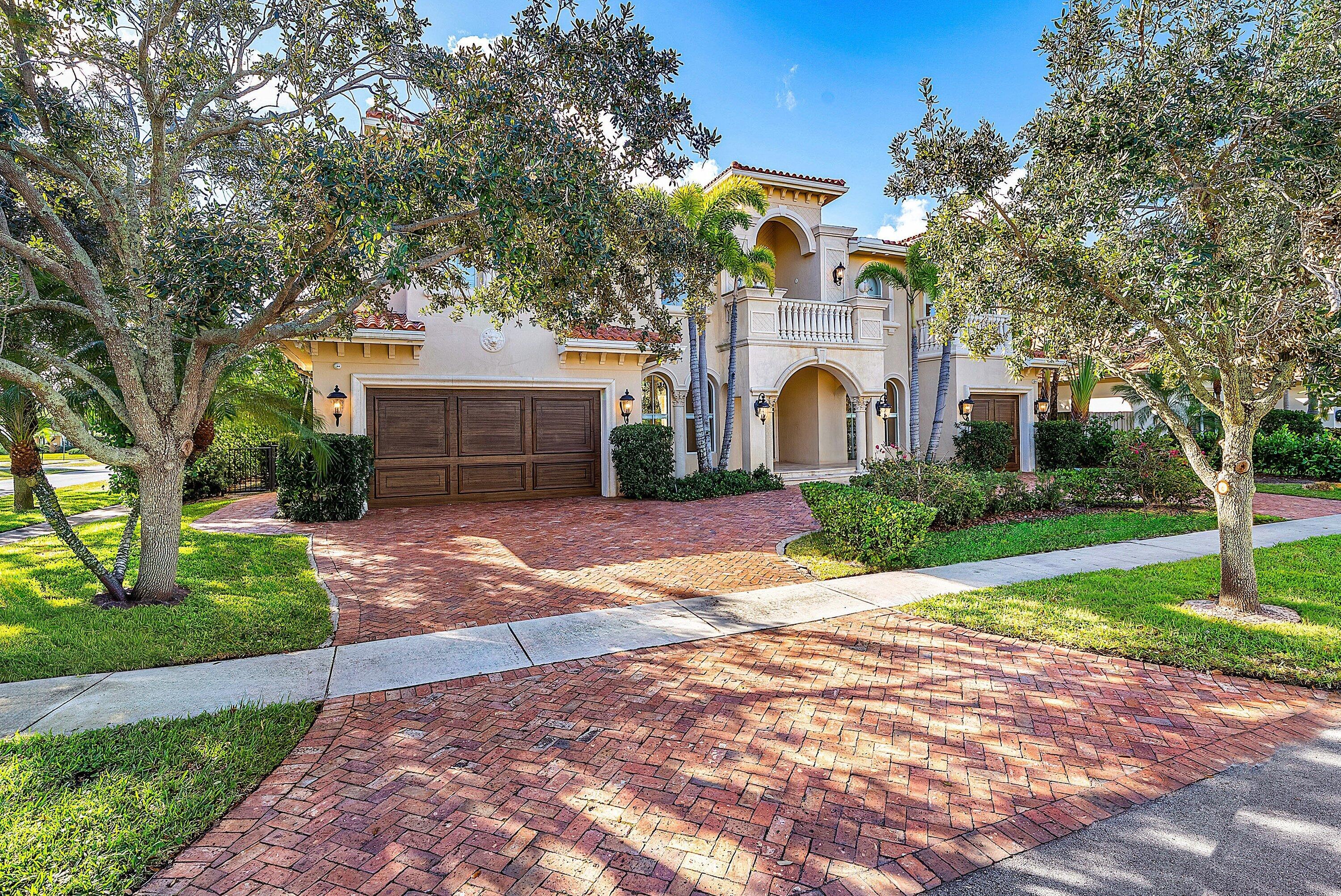 398 Northeast 7th Street Boca Raton, FL 33432 - Photo 2 of 74 a front view of a house with a garden and trees