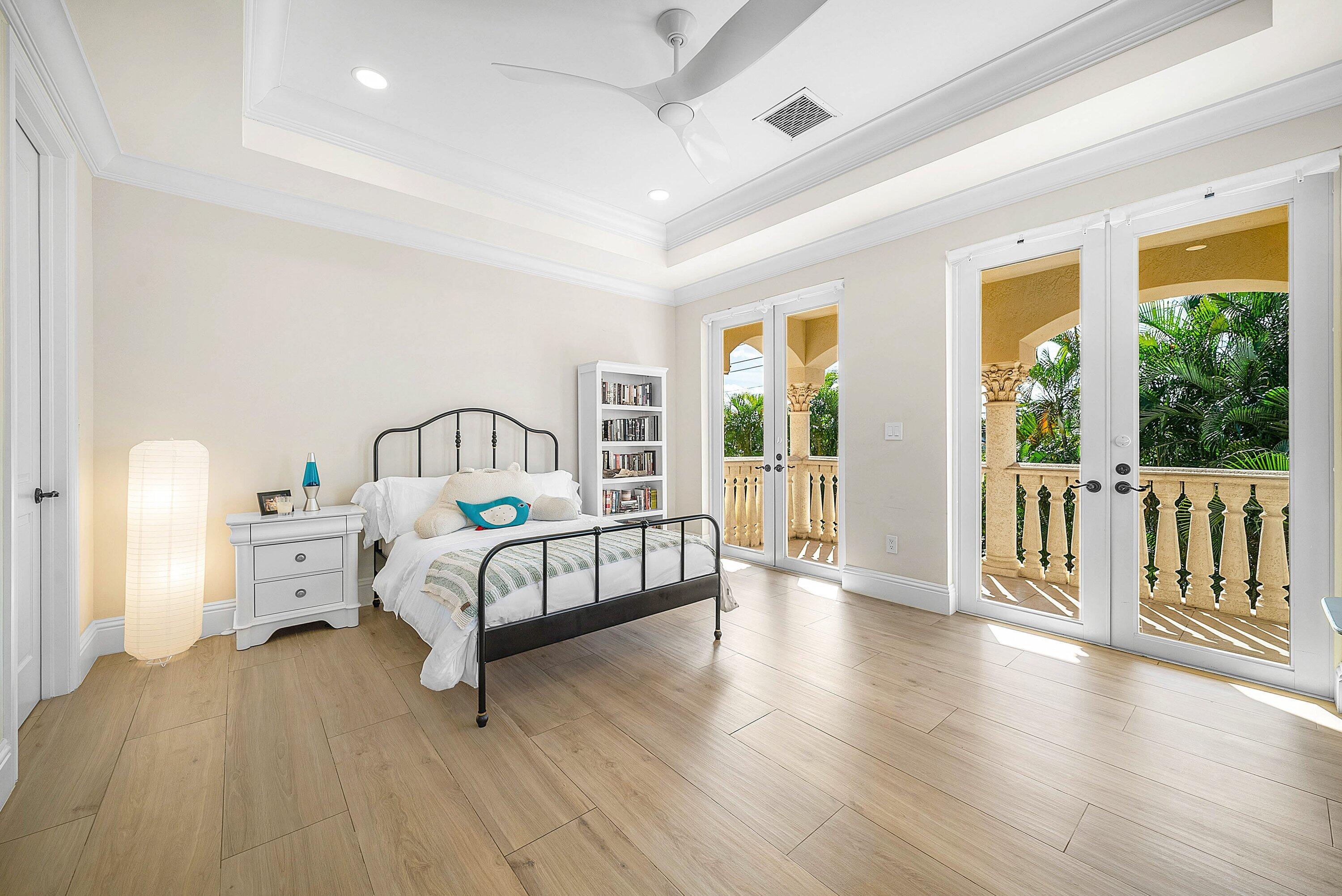 398 Northeast 7th Street Boca Raton, FL 33432 - Photo 43 of 74 a bedroom with a bed and wooden floor