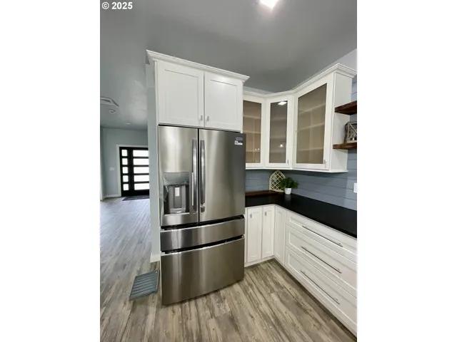 a kitchen with stainless steel appliances a refrigerator and microwave