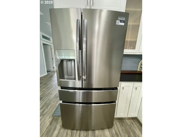 a kitchen with a refrigerator and cabinets