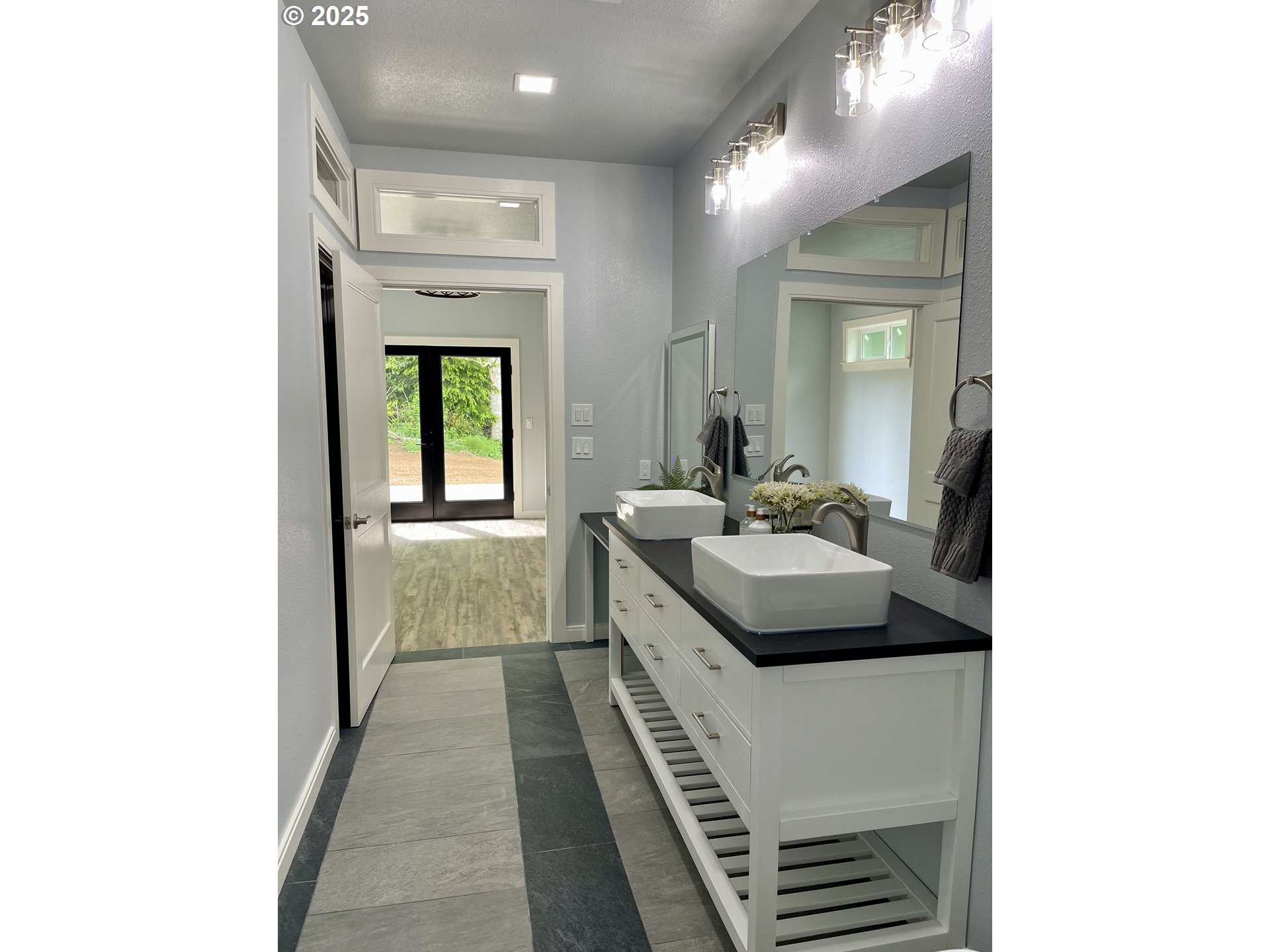 905 Bellevue Drive Reedsport, OR 97467 - Photo 21 of 37 a en suite bathroom with a sink and a mirror