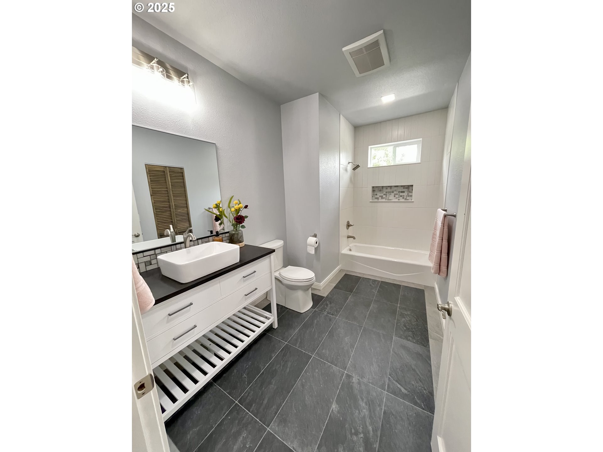 905 Bellevue Drive Reedsport, OR 97467 - Photo 27 of 37 a spacious bathroom with a sink a toilet and a mirror