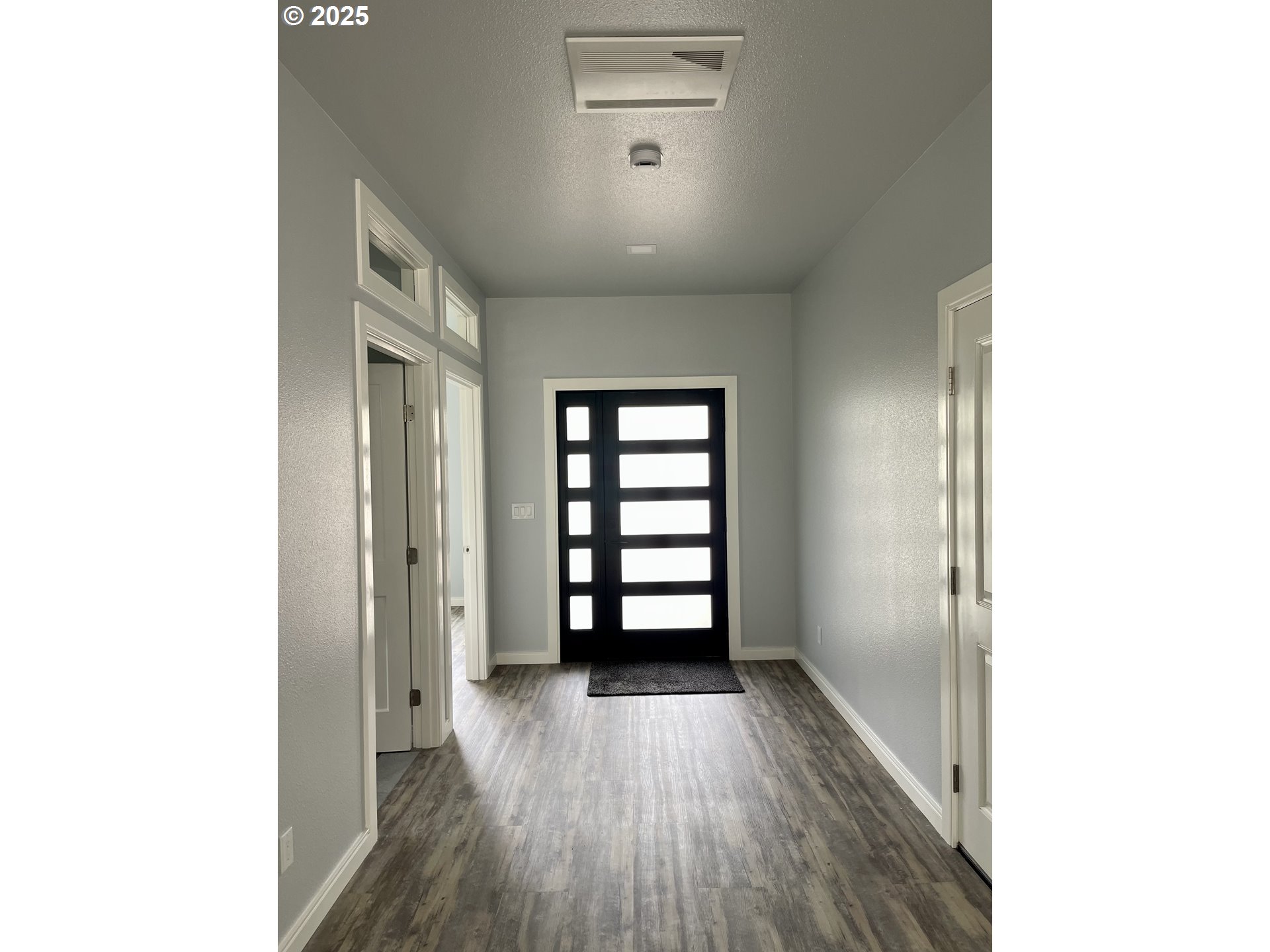 905 Bellevue Drive Reedsport, OR 97467 - Photo 3 of 37 a view of an empty room with wooden floor