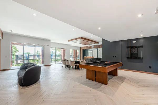 a living room with furniture a flat screen tv and a large window