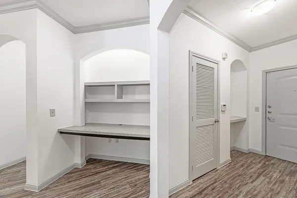 a view of a hallway with wooden floor and staircase