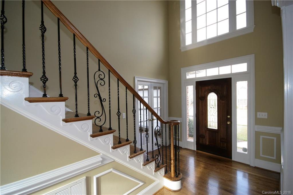 18628 Square Sail Road Cornelius, NC 28031 - Photo 2 of 19 a view of staircase with railing and a chandelier