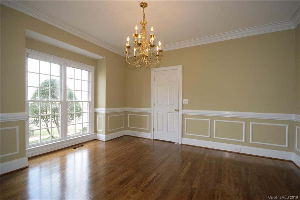 18628 Square Sail Road Cornelius, NC 28031 - Photo 4 of 19 a view of an empty room with wooden floor and a window
