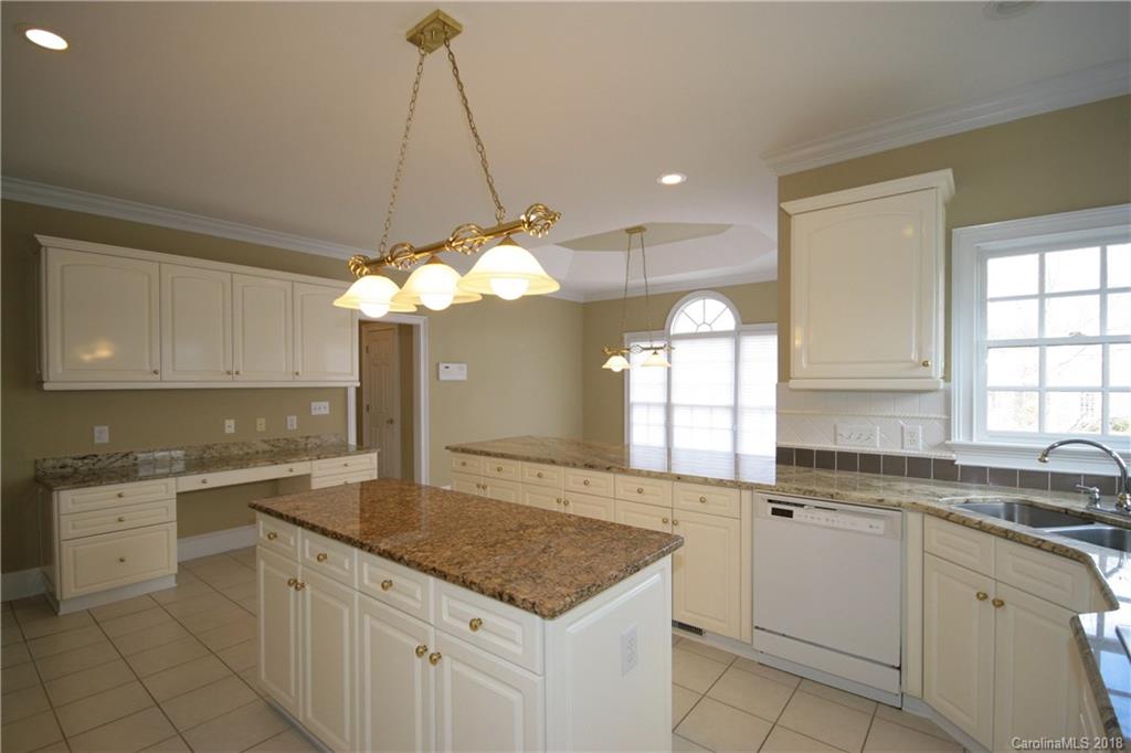 18628 Square Sail Road Cornelius, NC 28031 - Photo 9 of 19 a kitchen with a white center island and cabinets