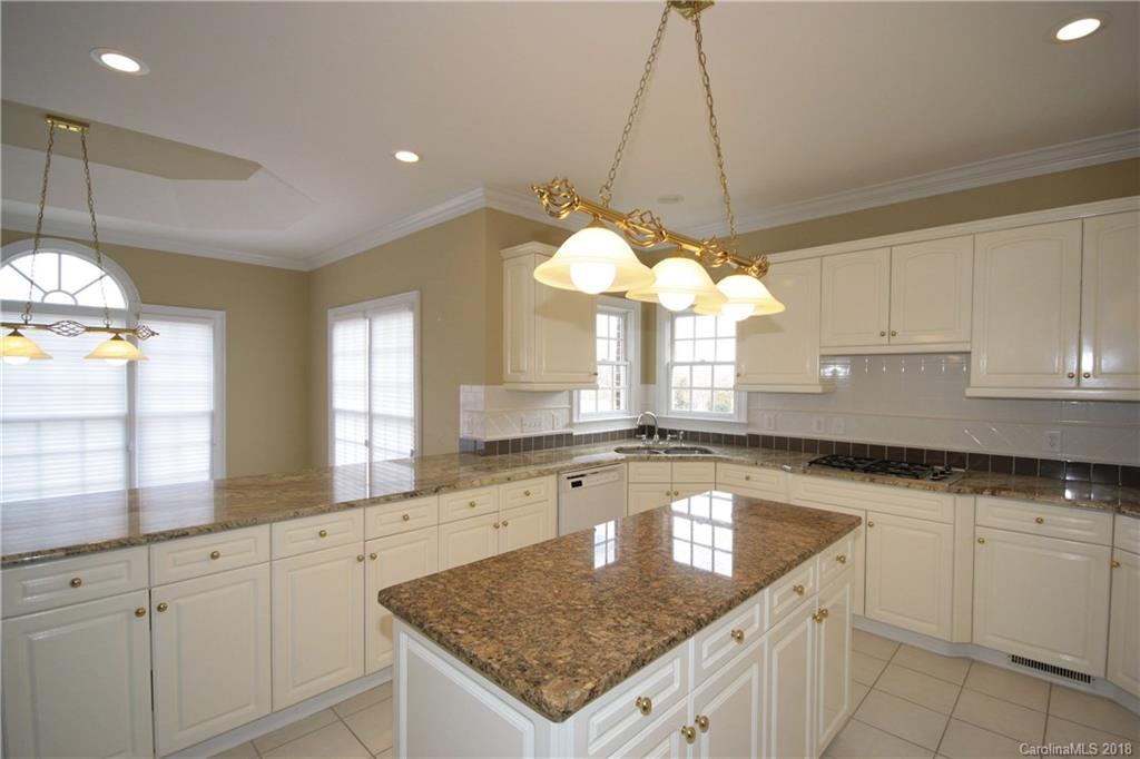 18628 Square Sail Road Cornelius, NC 28031 - Photo 10 of 19 a kitchen with a sink a center island and cabinets