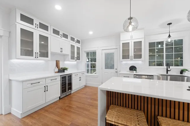 a kitchen with stainless steel appliances granite countertop a sink stove and cabinets
