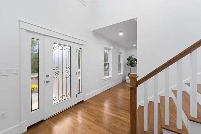 a view of an entryway with wooden floor