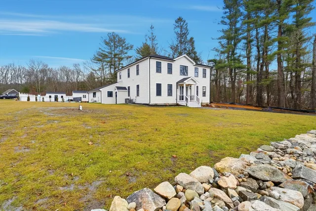 a view of an ocean with a house in the background