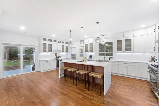 a large white kitchen with a large window