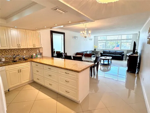 a kitchen with stainless steel appliances kitchen island granite countertop a sink and cabinets