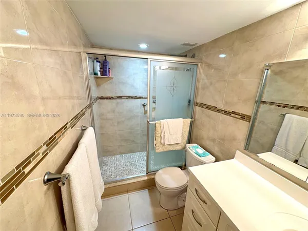 a bathroom with a toilet sink and shower