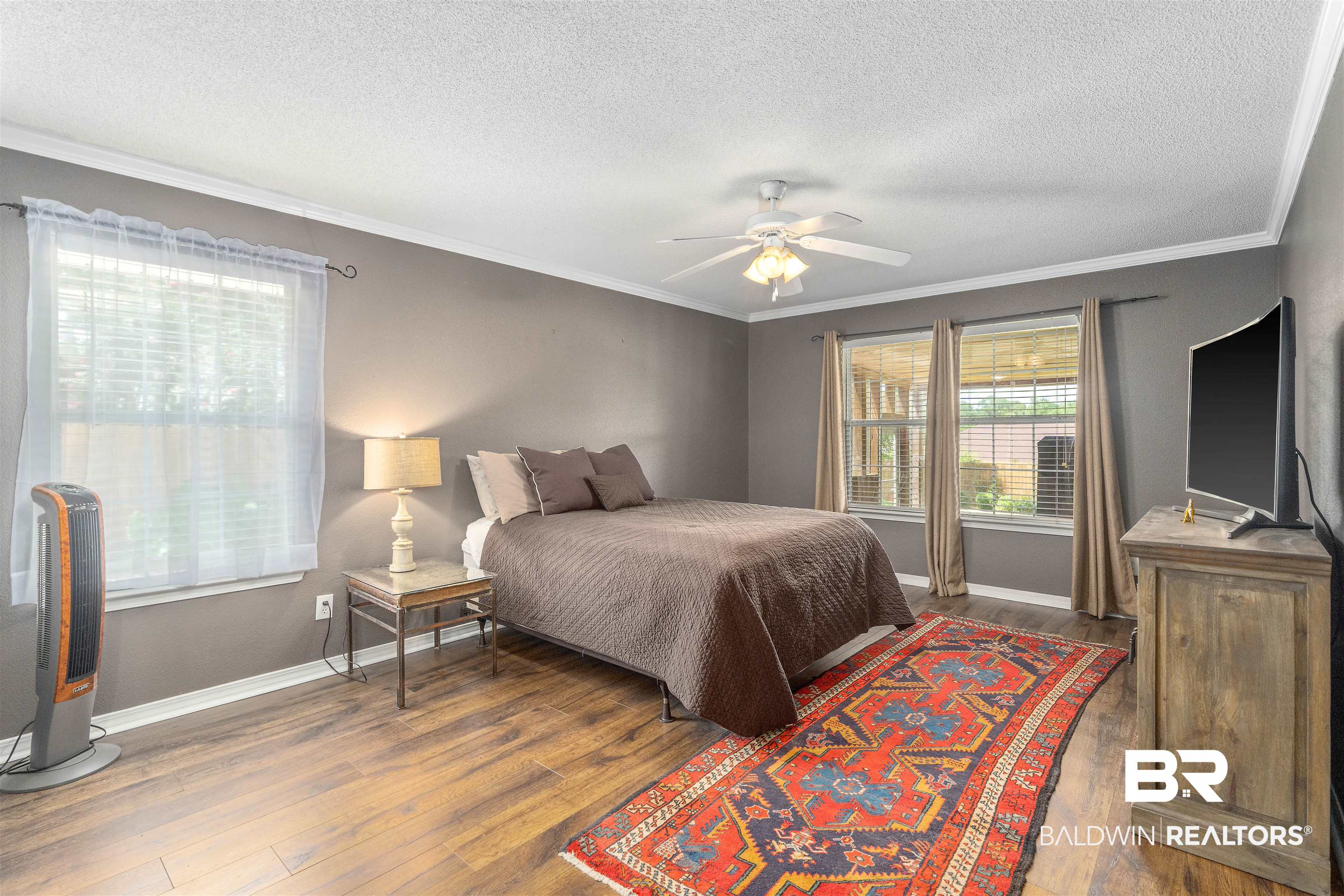11097 Pontchartrain Loop Daphne, AL 36526 - Photo 17 of 28 Bedroom with wood-type flooring, a textured ceiling, ornamental molding, and a ceiling fan