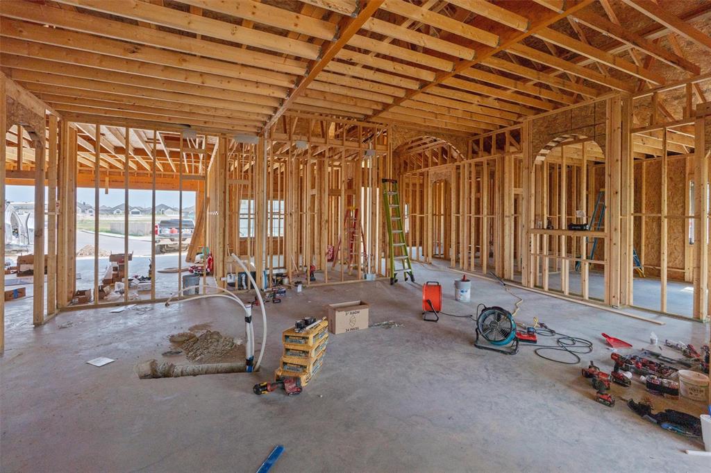 1405 Red Rock Road Hewitt, TX 76643 - Photo 16 of 25 New construction framing with exposed wooden beams, multiple arched wall openings, and concrete flooring