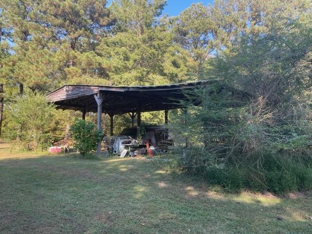 9945 Tracy Road Atoka, TN 38004 - Photo 10 of 19 a view of patio with a table and chairs under an umbrella